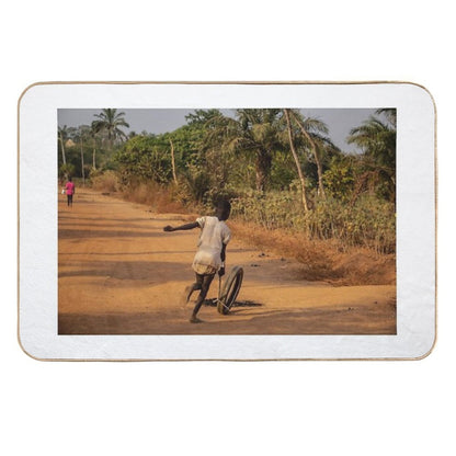 Africa Child Playing on The Village Street  Versatile Bath Mat